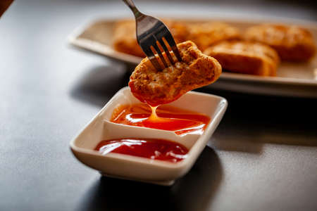 Chicken nuggets with a sauce add more flavor to the tasteの写真素材