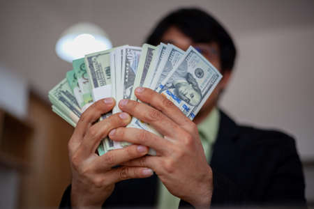 Young man showing off his money.の写真素材