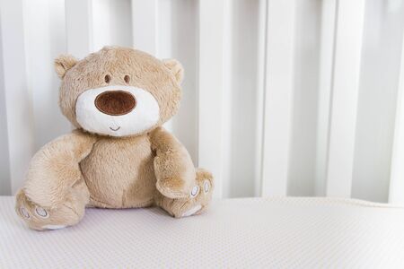 Teddy Bear sitting on the bedの写真素材