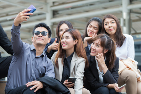 Smart young business people enjoyed take photo together outside the office and happy with their jobの写真素材