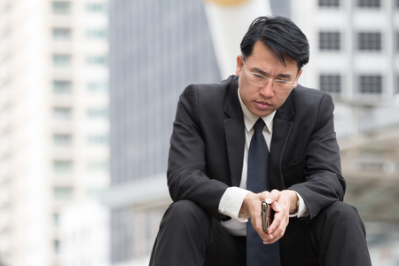 Stressed business man sitting with serious face and feel depressedの写真素材