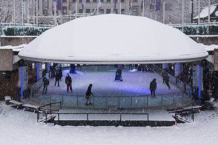 Vancouver, CANADA - 23 Feb, 2018 : Robson Square Ice Skate Rink in Winter. It has heavy snow.