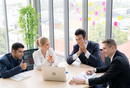 Group of business people are  discussing about the project in the meeting room with smiling face....