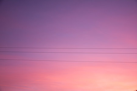 abstract winter sunset with details of power cablesの写真素材