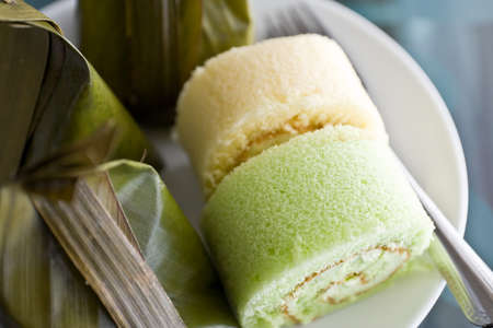 Thai desserts wrapped in banana leaves and steamed cooked with Bun stuffed with creamの写真素材