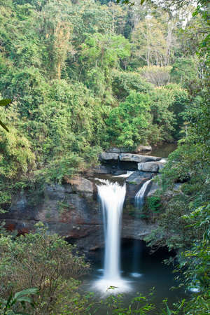 Waterfall surrounded by tropical forest in the summer in Thailand.の写真素材