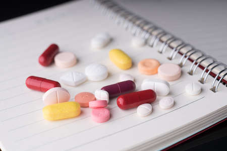 Medical pills on a notebook.の写真素材