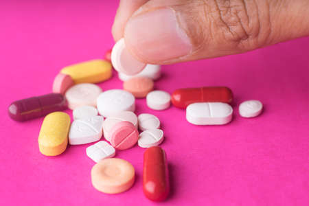 Medical pills on pink background.の写真素材