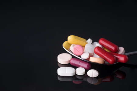 Spoon full of medical pills.の写真素材