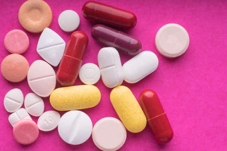medical pills and capsules on pink background.の写真素材