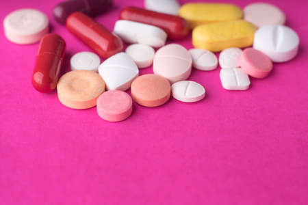 A lot of medical pills on pink background.の写真素材