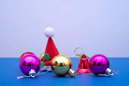 Christmas ornament balls and santa hat on grey background.の写真素材