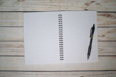 Pen and blank note paper on vintage wooden table.Background concept with copy space.の写真素材