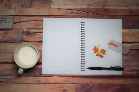 Pen and blank note paper on vintage wooden table.Background concept with copy space.の写真素材