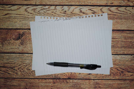 Pen and blank note paper on vintage wooden table.Background concept with copy space.の写真素材