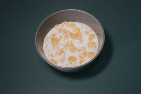Cornflake cereal in the bowl with full cream milk.の写真素材