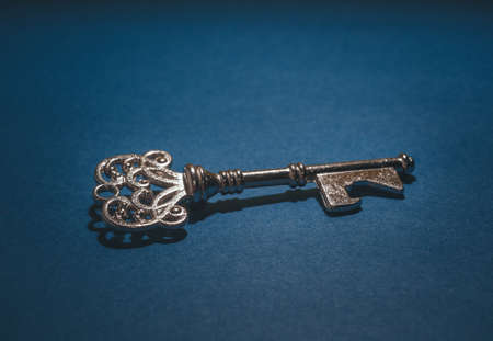 Vintage key close up on blue background.