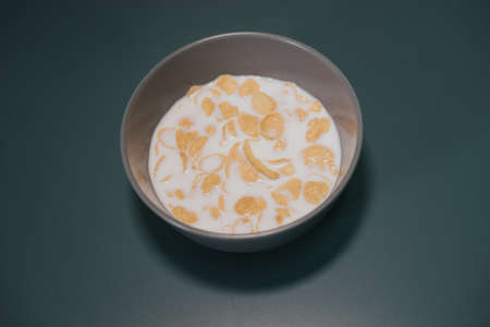 Cornflake cereal in the bowl with full cream milk.の写真素材