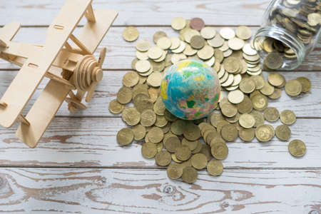 Wooden Airplane toy with world globe on white background.Travel Concept.の写真素材