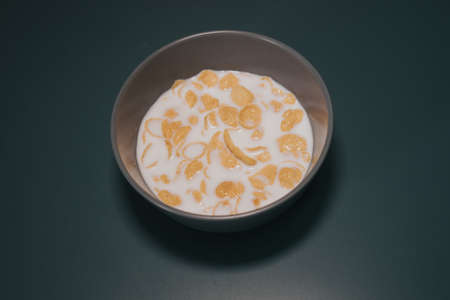 Cornflake cereal in the bowl with full cream milk.の写真素材