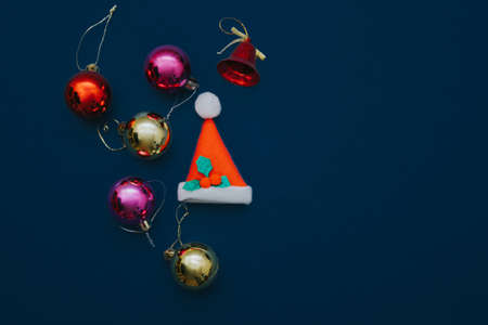 Christmas ornament balls and santa hat on grey background.の写真素材