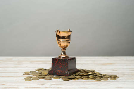 Golden Trophy on bed of coins.Successful financial plan concept.の写真素材