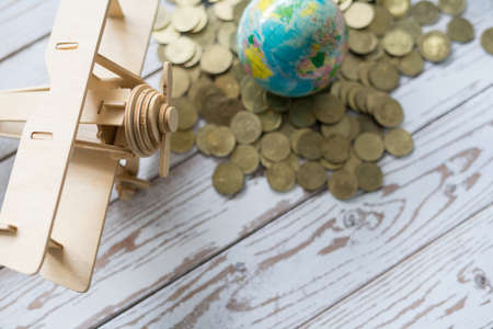 Wooden Airplane toy with world globe on white background.Travel Concept.の写真素材