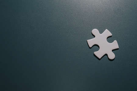 a piece of blank white puzzle on chalkboard.の写真素材