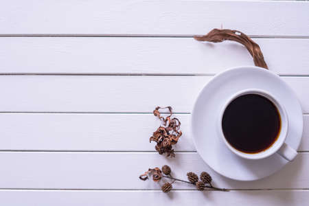 Black coffee in a white cup on white vintage wooden table view from top.Copy space.の写真素材