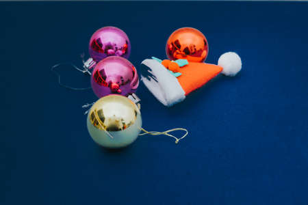 Christmas ornament balls and santa hat on grey background.の写真素材