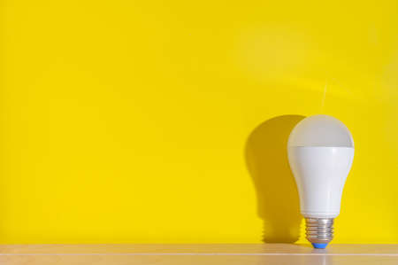 White bulb on yellow background.