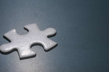 A piece of a blank white puzzle on the chalkboard with copy space.の写真素材
