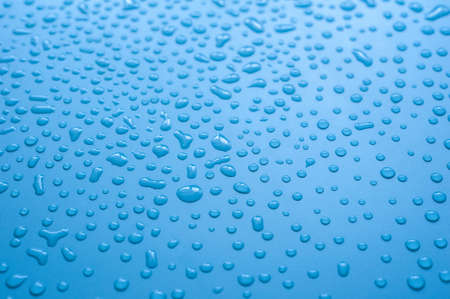 Water drop on blue background.の写真素材