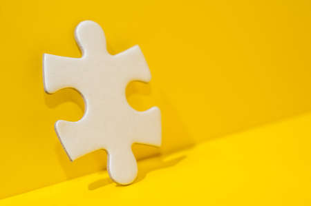 A piece of Blank white puzzle on yellow background with copy space.Problem and solution concept.の写真素材