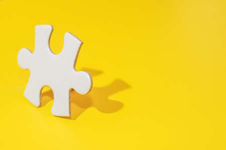 A piece of Blank white puzzle on yellow background with copy space.Problem and solution concept.の写真素材