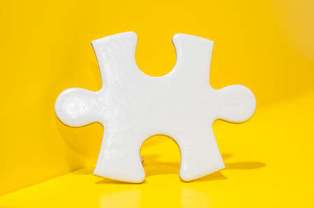 A piece of Blank white puzzle on yellow background with copy space.Problem and solution concept.の写真素材