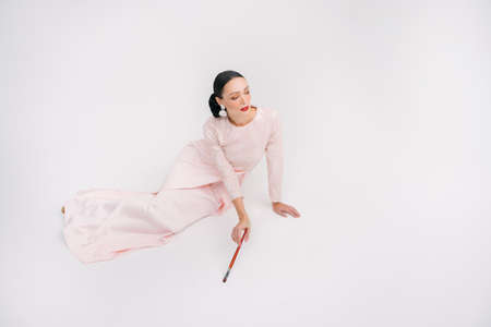 Modern female fashion fro Eid Ul Fitr celebration or formal event.Muslim female fashion.Beautiful female model holding paint brush isolated on white background.の写真素材