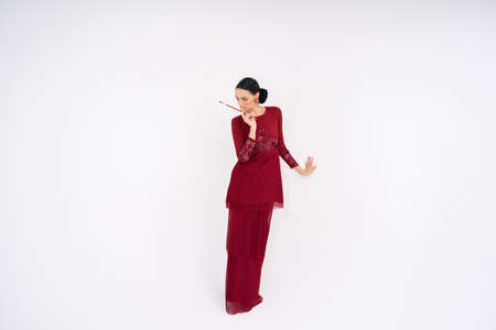 Beautiful female models wearing Asian traditional dress for Muslim woman isolated over white background. Eid al fitr fashion and beauty.の写真素材