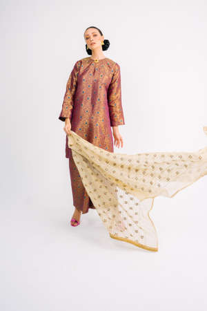 Beautiful female model wearing traditional Malay dress and scarf isolated over white background.Fashion for Muslim Female.の写真素材