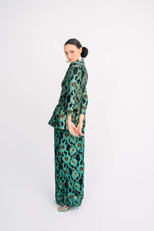 Beautiful model wearing modern traditional Malay dress isolated over white background.の写真素材