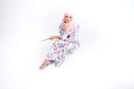Beautiful Arab Female model wearing hijab isolated over white background.Close up shot.Hijab Fashion.の写真素材