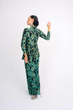 Beautiful model wearing  modern traditional Malay dress isolated over white background.の写真素材