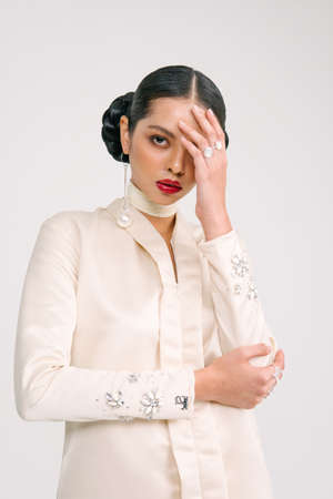 Beautiful girl wearing Baju Kurung (Asian Malay traditional dress) isolate over white background.Modern female fashion fro Eid Ul Fitr celebration or formal event.の写真素材
