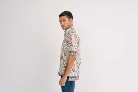 Handsome Asian Male model wearing casual batik shirt isolated over white background.の写真素材