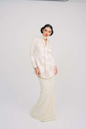 Beautiful female model wearing Asian traditional dress for Muslim woman isolated over white background.Eid ul fitr fashion and beauty.の写真素材