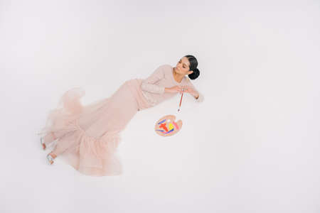 Beautiful female model wearing Asian traditional dress for Muslim woman isolated over white background. Eid al fitr fashion and beauty.の写真素材