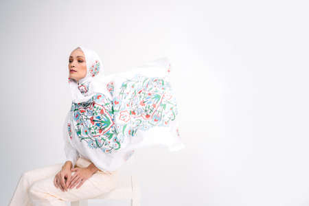 Beautiful Arab Female model wearing hijab isolated over white background.Close up shot.Hijab Fashion.