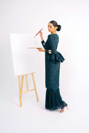 Beautiful model wearing Baju Kebaya modern (traditional Malay dress) isolated over white background.の写真素材