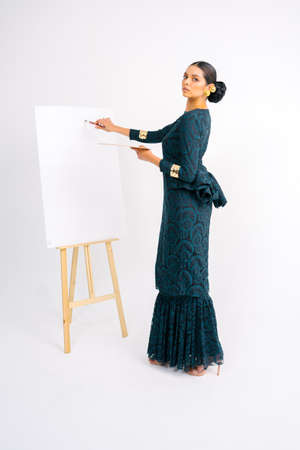 Beautiful model wearing Baju Kebaya modern (traditional Malay dress) isolated over white background.の写真素材