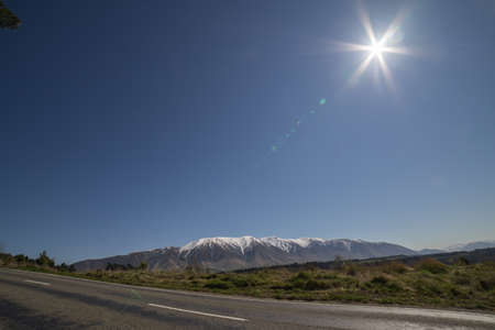 New Zealand scenic route with snowcap mountain in background.の写真素材